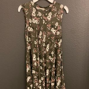 A beautiful dark green dress with white and pink flowers decorated around it.